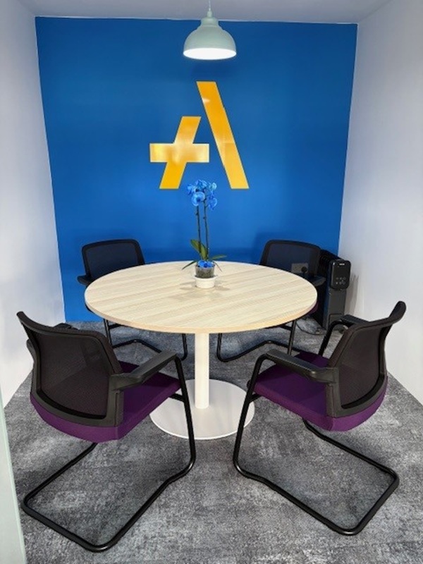 An image of an accent wall with the TaxAssist logo in one of the office spaces.